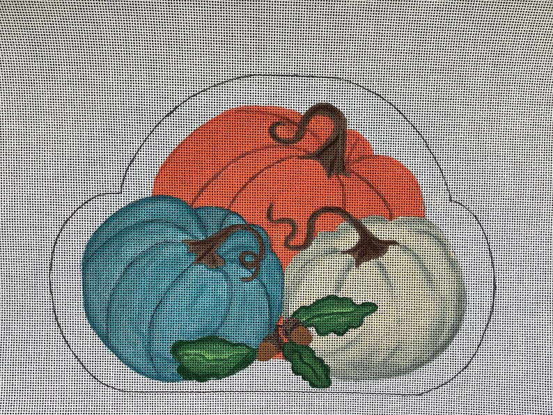 May include: Three pumpkins in a circle, one is orange, one is blue, and one is white. They have brown stems and green leaves.