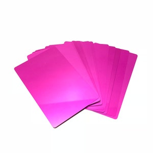 May include: A stack of pink playing cards fanned out in a semi-circle.