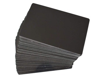 May include: A stack of black blank plastic cards, likely for use as gift cards or loyalty cards.