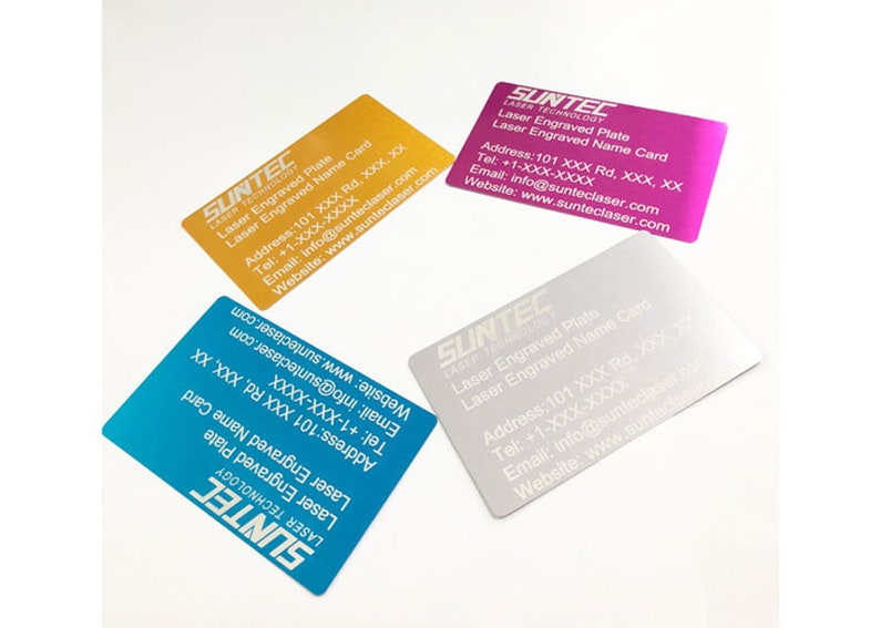 May include: Four business cards with a silver, gold, pink, and blue metallic finish. The cards have white text that reads "SUNTEC LASER TECHNOLOGY" and includes contact information for the company. The text on the cards reads "Laser Engraved Plate" and "Laser Engraved Name Card".