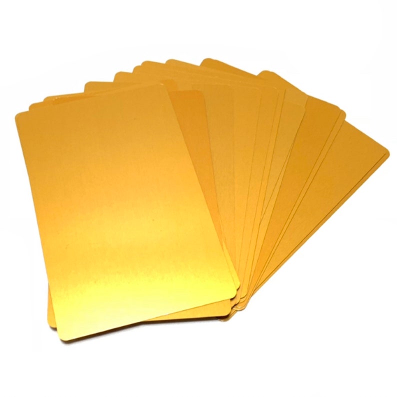 May include: A stack of blank, gold-colored cardstock paper.
