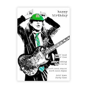 May include: A black and white birthday card featuring a musician playing a guitar, wearing a green cap and tie. The words "happy birthday" are at the top. Lyrics are printed on the right side of the card.