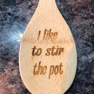 May include: A wooden spoon with the text "I like to stir the pot" engraved on it.