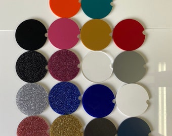 May include: Assortment of 16 round coasters in various colors and textures, including solid colors, glitter, and plain white. The coasters are arranged in a grid pattern.