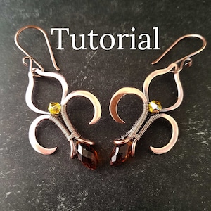 May include: A pair of copper wire earrings with a fleur-de-lis design and amber and yellow glass beads. The earrings are hanging from a dark background. The word "Tutorial" is written in white text above the earrings.