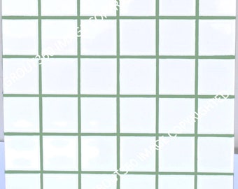 May include: Square white tiles with green grout lines, arranged in a grid pattern. The tiles are evenly spaced, creating a clean and modern look. The image is a close-up, showcasing the tile's texture and color.