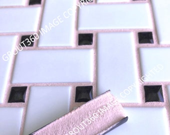 May include: Close-up of a tile pattern featuring white rectangular tiles, black square accents, and pink grout. A trowel with pink material is in the foreground, suggesting tile installation or repair. The design is geometric and modern.