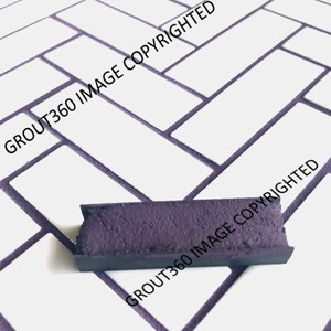 May include: A rectangular piece of dark purple grout with a textured surface. The grout is set against a white tile background with dark purple grout lines. The image is labeled with the text "GROUT360 IMAGE COPYRIGHTED".