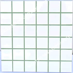 May include: Square white tiles with green grout lines, arranged in a grid pattern. The tiles are evenly spaced, creating a clean and modern look. The green grout provides a subtle contrast to the white tiles.