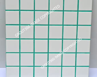 May include: Square white tiles with teal grout lines, arranged in a grid pattern. The tiles are evenly spaced, creating a clean and modern look. The image is a close-up of a tiled surface, suitable for home decor or design projects.