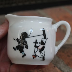 Black & White Creamer Germany porcelain china boy w/ broom, girl w/ bottle pacifier cross, and goose