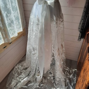 Floral bridal overskirt in off-white. Embroidered tulle with trailing flowers and leaves, perfect for a winter wedding.