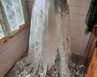 Floral bridal overskirt in off-white. Embroidered tulle with trailing flowers and leaves, perfect for a winter wedding.
