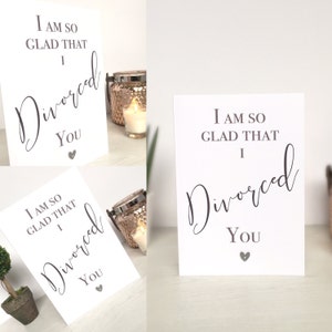 May include: Two white cards with black text that reads "I am so glad that I divorced you" with a small gray heart at the bottom of each card.