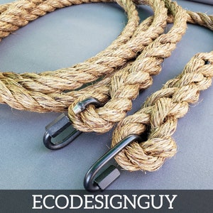 May include: Two natural fiber ropes with black metal clasps. The ropes are twisted together and are lying on a gray surface.