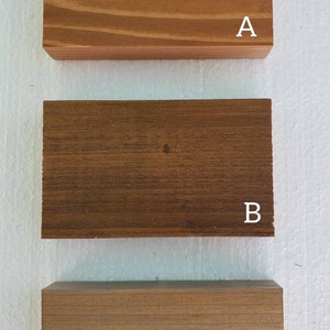 May include: Three wooden samples labeled A, B, and C. Sample A is a light brown wood with a smooth finish. Sample B is a dark brown wood with a rougher finish. Sample C is a medium brown wood with a smooth finish.