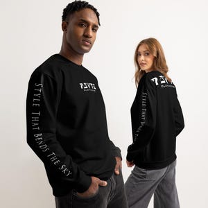 May include: Two people wearing black sweatshirts. The sweatshirts have white text on the sleeves and the chest. The text on the sleeves reads "STYLE THAT BENDS THE SKY". The chest text reads "PSYTE CLOTHING".