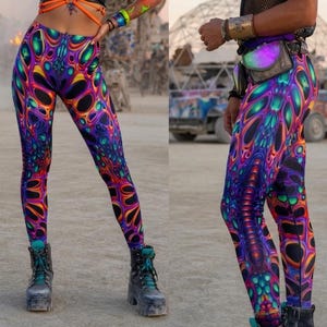 May include: Three people wearing vibrant, psychedelic-patterned leggings and tops. The outfits feature a mix of purple, blue, green, and orange colors. Accessories include goggles, masks, and body jewelry. The image includes the text "PSYTE CLOTHING".