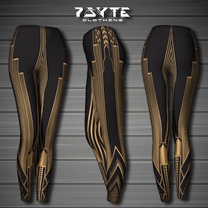 May include: Black leggings with a gold geometric pattern. The leggings have a high waist and a slim fit. The pattern is reminiscent of Art Deco design.