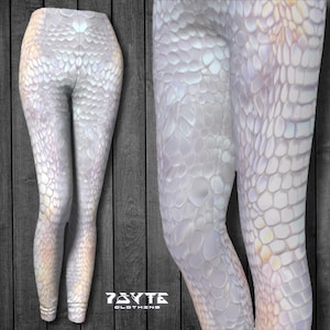 May include: White leggings with a pearlescent snake skin pattern. The leggings are form-fitting and have a high waist.