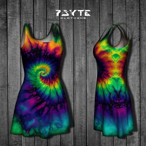 May include: A tie-dye sleeveless dress with a swirling pattern in shades of orange, yellow, green, blue, and purple. The dress has a fitted bodice and a flared skirt. The dress is photographed against a woodgrain background.