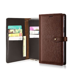 May include: A brown leather phone case with a wallet attached. The wallet has multiple card slots and a money pocket. The case has a flap that closes with a snap.