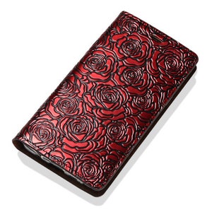 May include: A red leather phone case with a rose pattern embossed on the surface.