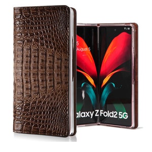 May include: A brown leather phone case with a crocodile pattern. The case is closed and the phone is visible inside. The phone is a Samsung Galaxy Z Fold2 5G.