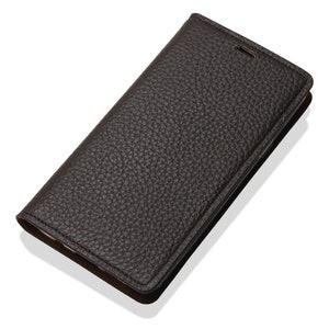 May include: A black leather phone case with a textured surface.