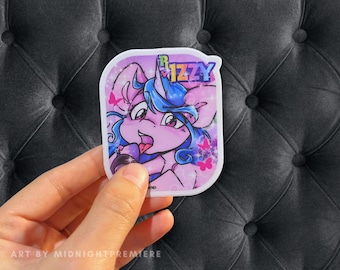 May include: A sticker featuring a cartoon unicorn with blue hair and pink fur, holding a microphone. The unicorn is wearing a blue shirt and has a pink background with glitter and butterflies. The text "Rizzy" is written in rainbow letters on the sticker.