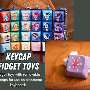 May include: A set of colorful keycap fidget toys featuring My Little Pony characters. The keycaps are removable and can be used on electronic keyboards. Keycap Fidget Toys.