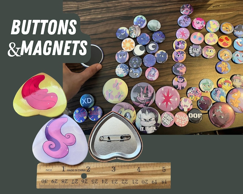 May include: A collection of colorful buttons and magnets featuring various cartoon characters and designs. The buttons are round and have a shiny finish. The magnets are heart-shaped and have a matte finish. The text "BUTTONS & MAGNETS" is visible at the top of the image.
