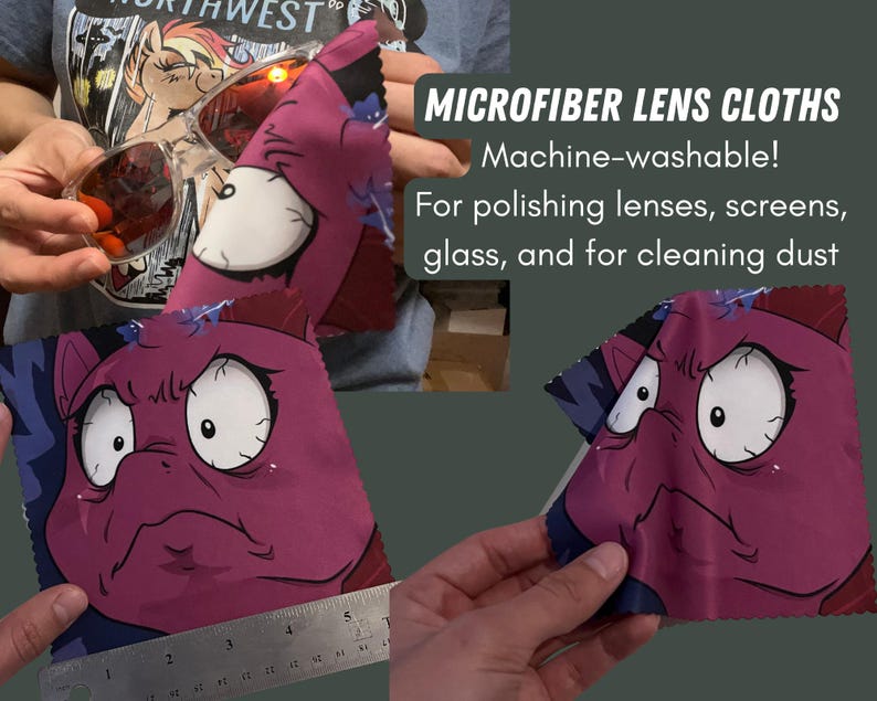 May include: Two microfiber lens cloths with a cartoon character design. The cloths are purple and blue with a white cartoon character with large eyes and a frown. The text "MICROFIBER LENS CLOTHS" is written in black on a white background. The text "Machine-washable!" is written in black on a white background. The text "For polishing lenses, screens, glass, and for cleaning dust" is written in black on a white background.
