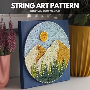 May include: A string art piece depicting a mountain landscape with a yellow sun and green trees. The artwork is set against a blue background and framed in a square shape. The text "STRING ART PATTERN DIGITAL DOWNLOAD" is at the top.