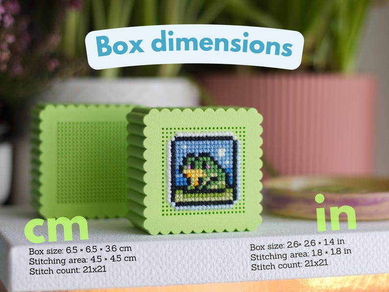 Cross stitch box STL file dimensions — 6.5 × 6.5 × 3.6 cm, stitching area 4.5 × 4.5 cm, 21×21 stitch count, shown printed in green PLA