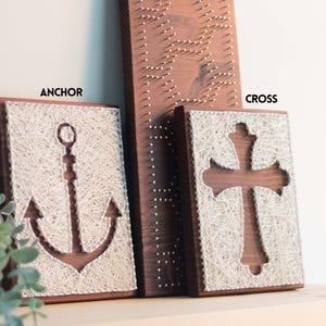 Stress relief string art craft kit with anchor and cross designs on stained wood base, beginner friendly DIY hobby for adults.