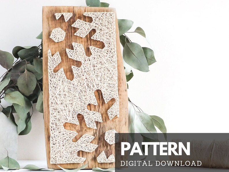 May include: A digital download pattern for a string art snowflake design. The pattern is displayed on a wooden board with white string wrapped around nails to create the snowflake shape. The pattern is perfect for creating a unique and festive wall hanging.