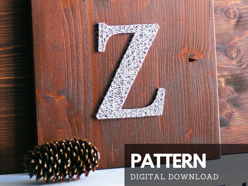 May include: A white string art pattern of the letter Z on a brown wooden background. The text "PATTERN DIGITAL DOWNLOAD" is below the letter.