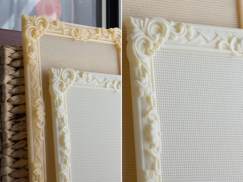 May include: Two rectangular frames featuring intricate, raised scrollwork and floral relief patterns along the borders. The frames are off-white in color and contain a fine, grid-like mesh material within the center, providing a textured surface.