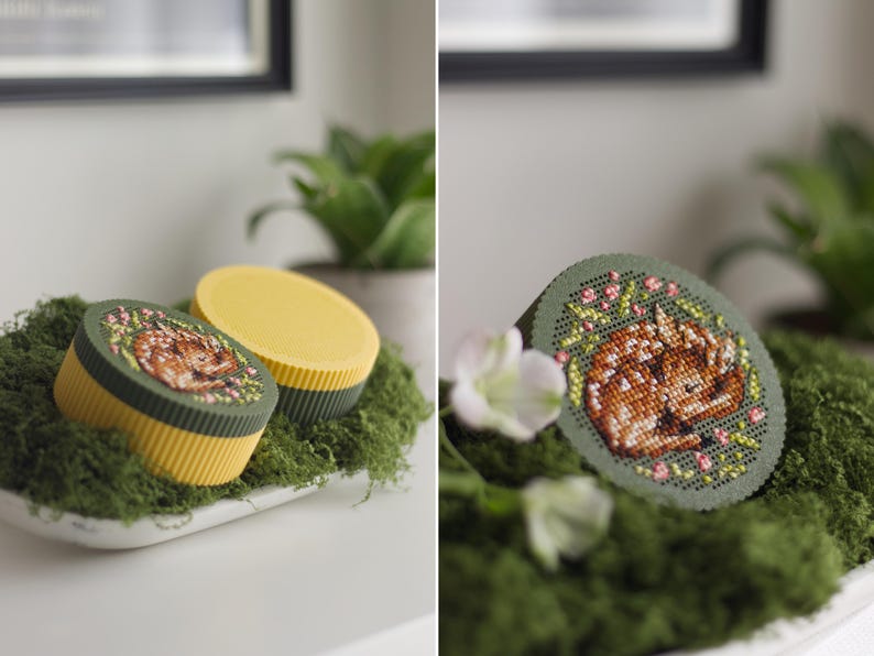 Round cross stitch box STL file — 3D printed yellow and green keepsake box with sleeping fawn embroidery on the lid, shown open and in close-up detail