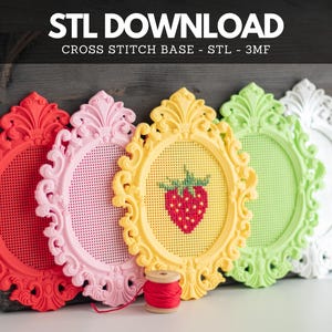 May include: Five oval frames with ornate scrollwork borders in red, pink, yellow, light green, and white. Each frame features a perforated grid center for cross-stitching. The yellow frame displays a stitched strawberry. Text reads: STL DOWNLOAD CROSS STITCH BASE - STL - 3MF.