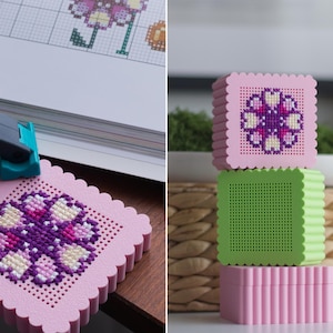 3D printed pink cross stitch keepsake box closed and open — purple flower embroidery on perforated lid with jewellery inside