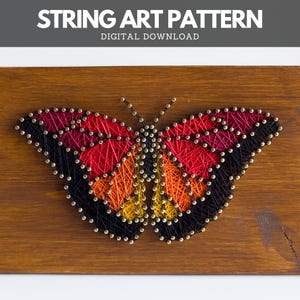 Finished butterfly string art design made using a printable pattern – DIY digital download with red, orange, and yellow thread on wooden board