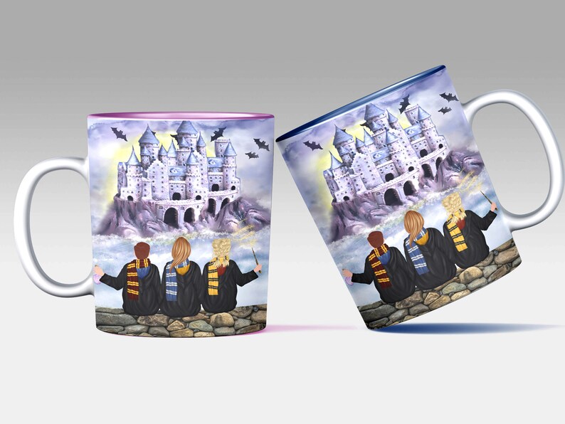 May include: Two white ceramic mugs with a colorful illustration of a castle and three figures wearing robes and holding wands. The mugs have a pink and blue rim.