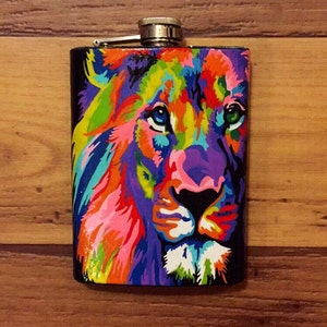May include: A stainless steel flask with a colorful lion design. The lion is painted in shades of pink, purple, green, yellow, orange, and blue.