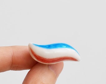 Toothpaste pin. Blue, red, white Ceramic. Tooth teeth dentist