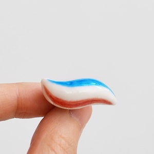 Toothpaste pin. Blue, red, white Ceramic. Tooth teeth dentist