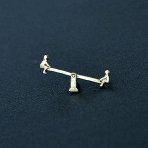 Seesaw. Articulated brass pin. Handmade