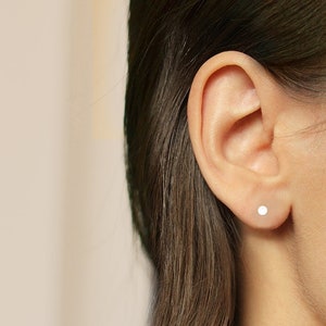 Asymetrical stud earrings. Silver disks image 5