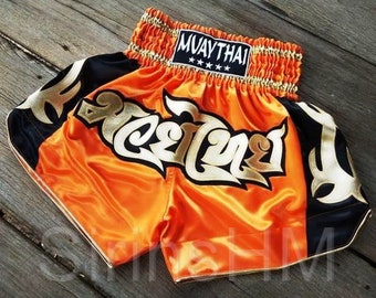 Muay Thai Boxing Shorts for Adult - Orange and Black Side with Gold Thai Pattern Stripes